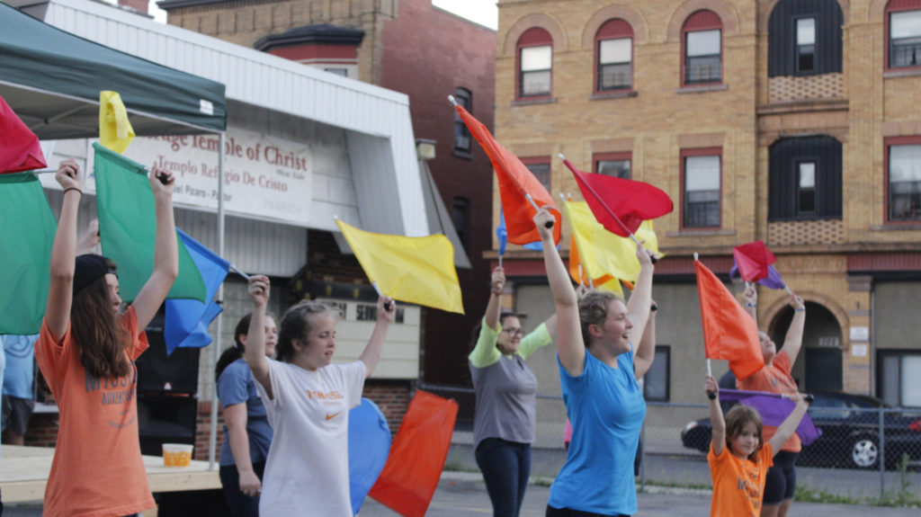 Team members dancing with flags