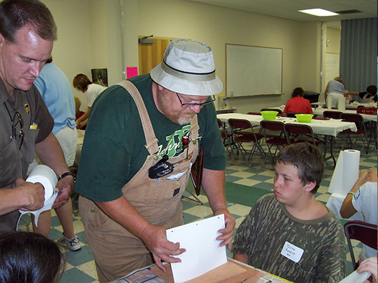 Red Jeffries helping a child with crafts